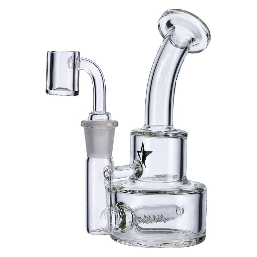 A three-quarter view of the Famous X 6" Stack Dab Rig, showcasing its clear glass construction and compact size.