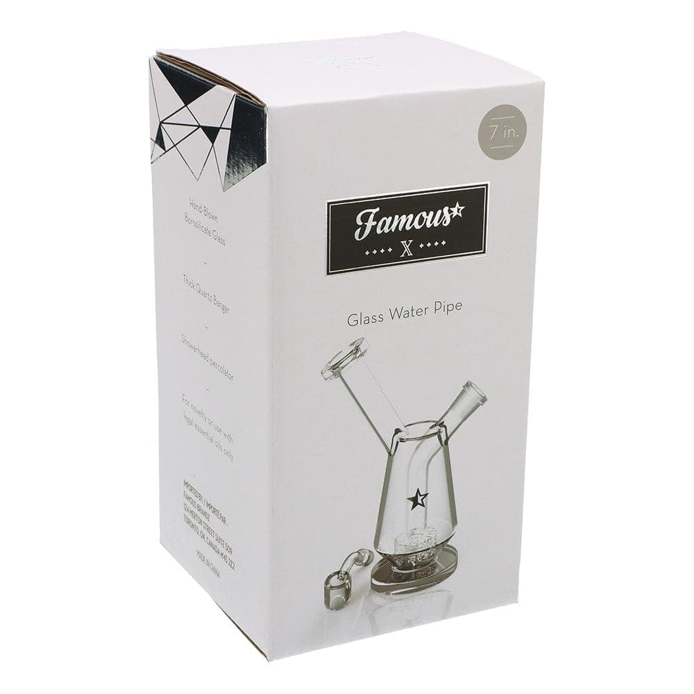 Front view of the Famous X 7" Drip Dab Rig, a clear glass rig with a rounded base and upward-angled mouthpiece.