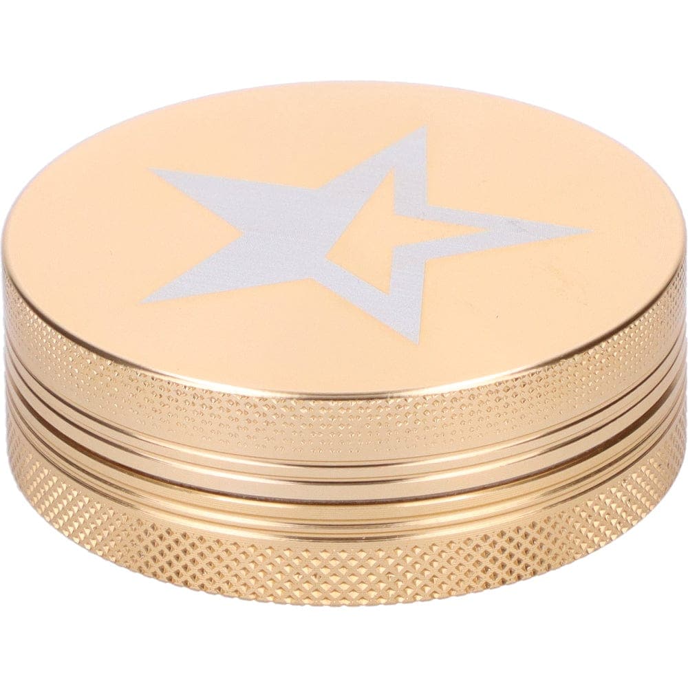A close-up, angled view of the gold Famous X 55mm 1-Stage Grinder, showing its textured metal finish.