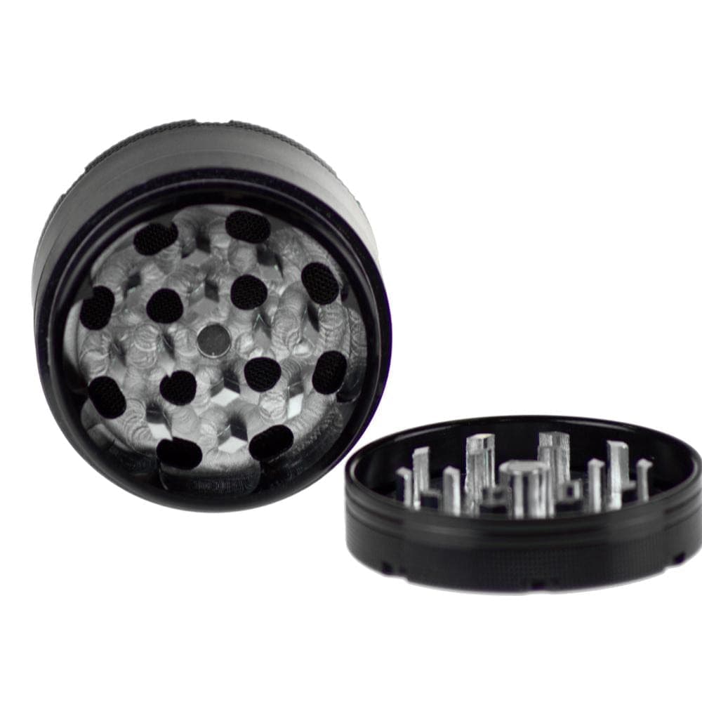 Close-up, top-down view of the Famous X Up In Smoke 50mm 4-Piece Grinder, showcasing the textured grinding teeth inside the metal compartment.