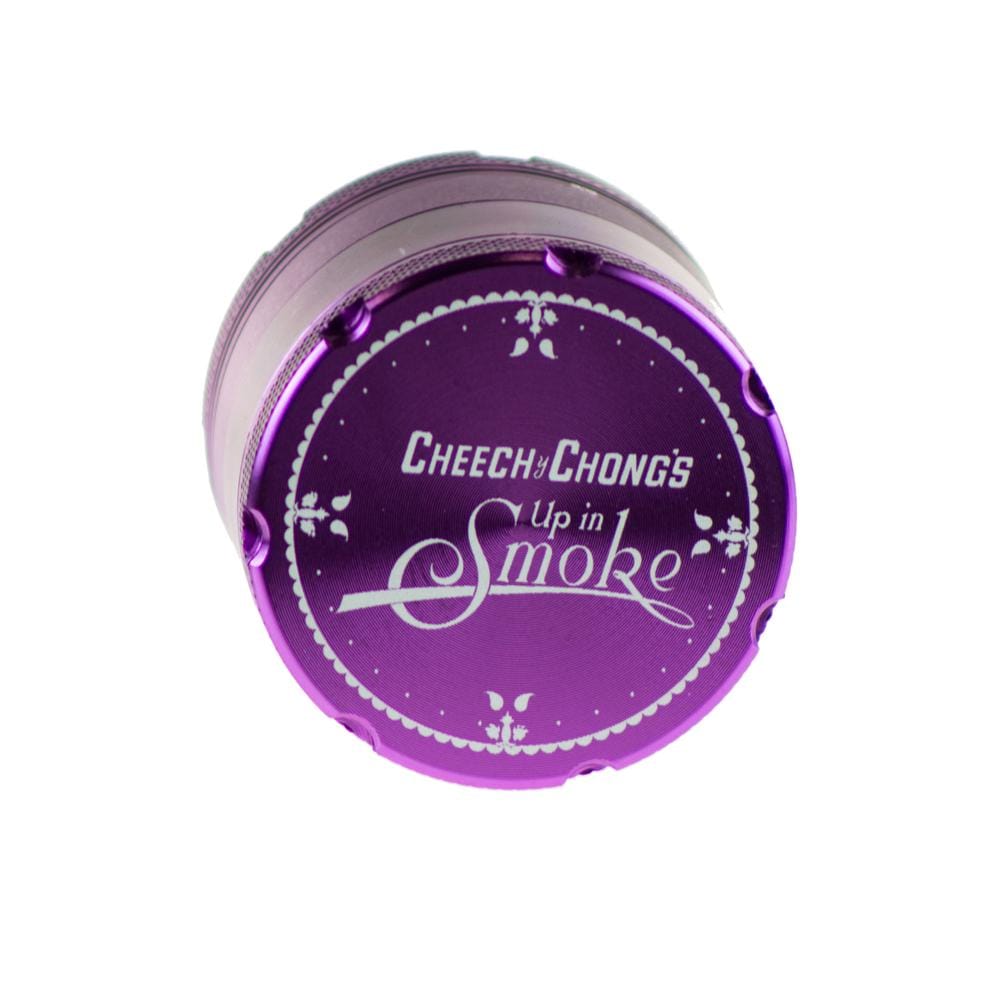 A close-up, angled view of the Famous X Up In Smoke 50mm 4-Piece Grinder, featuring a metallic purple finish and circular design.