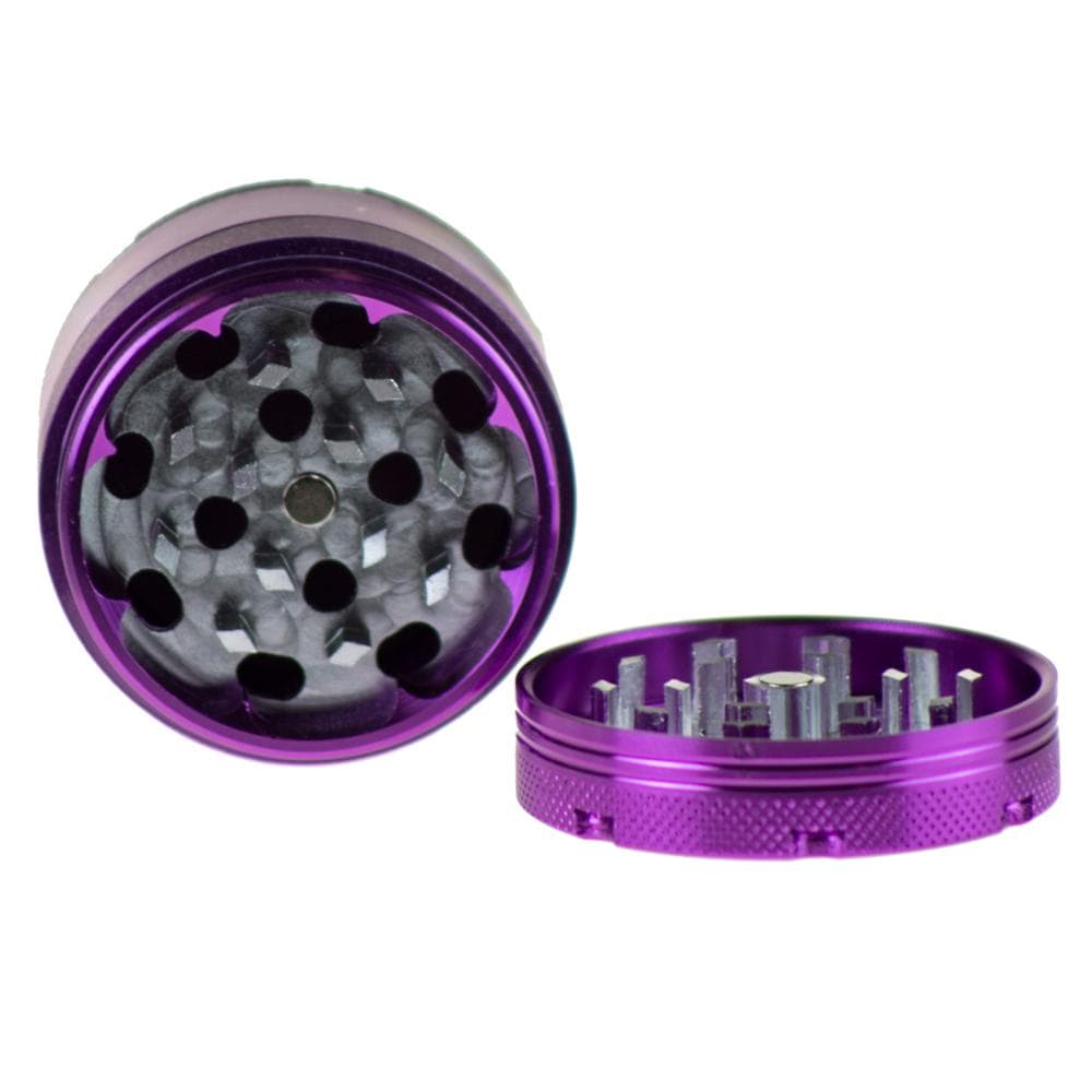 A top-down view of the open Famous X Up In Smoke 50mm 4-Piece Grinder, displaying its multiple grinding teeth.