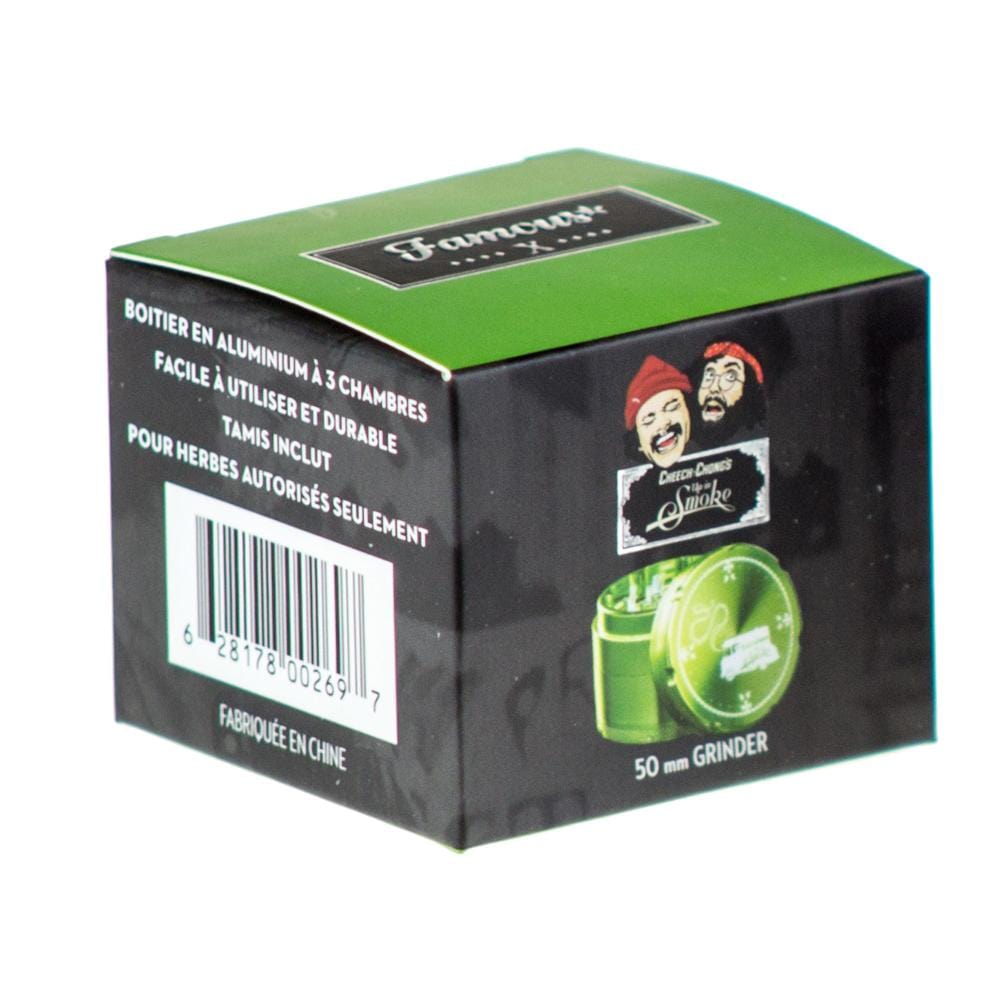 Front view of the Famous X Up In Smoke 50mm 4-Piece Grinder, showing a silver metal grinder with text labels in a studio setting.