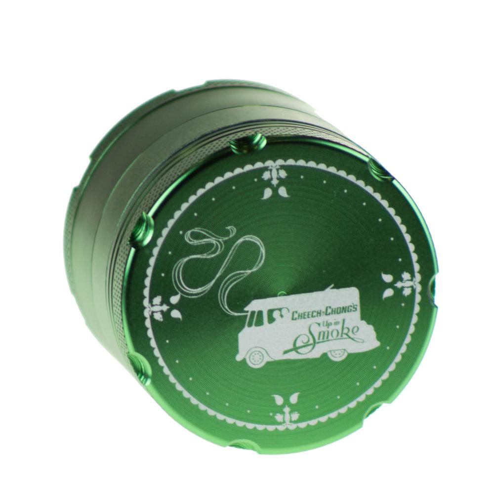 A top-down view of the Famous X Up In Smoke 50mm 4-Piece Grinder, showing its circular metallic finish and layered construction.