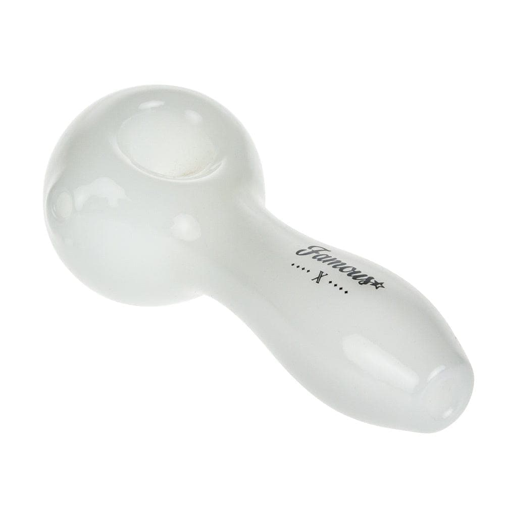 A top-down view of the Famous X 4" Spoon Pipe, showcasing its smooth, curved design in a simple composition.