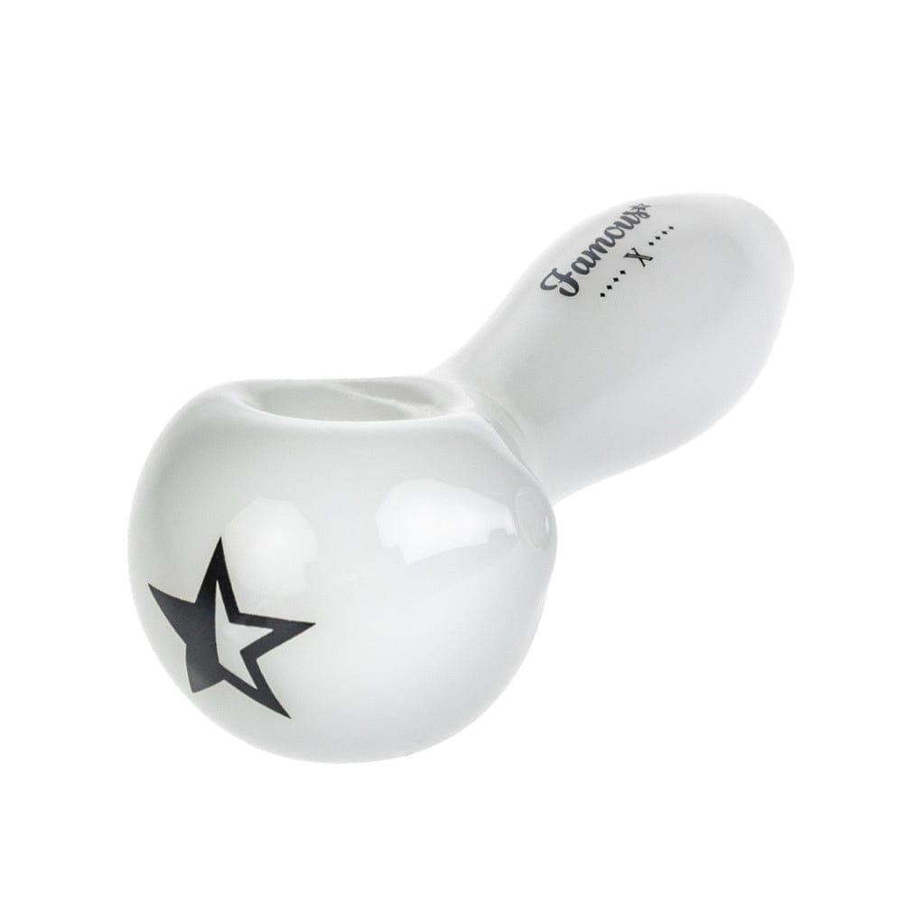 A three-quarter view of the Famous X 4" Spoon Pipe, showcasing its smooth, white ceramic design.