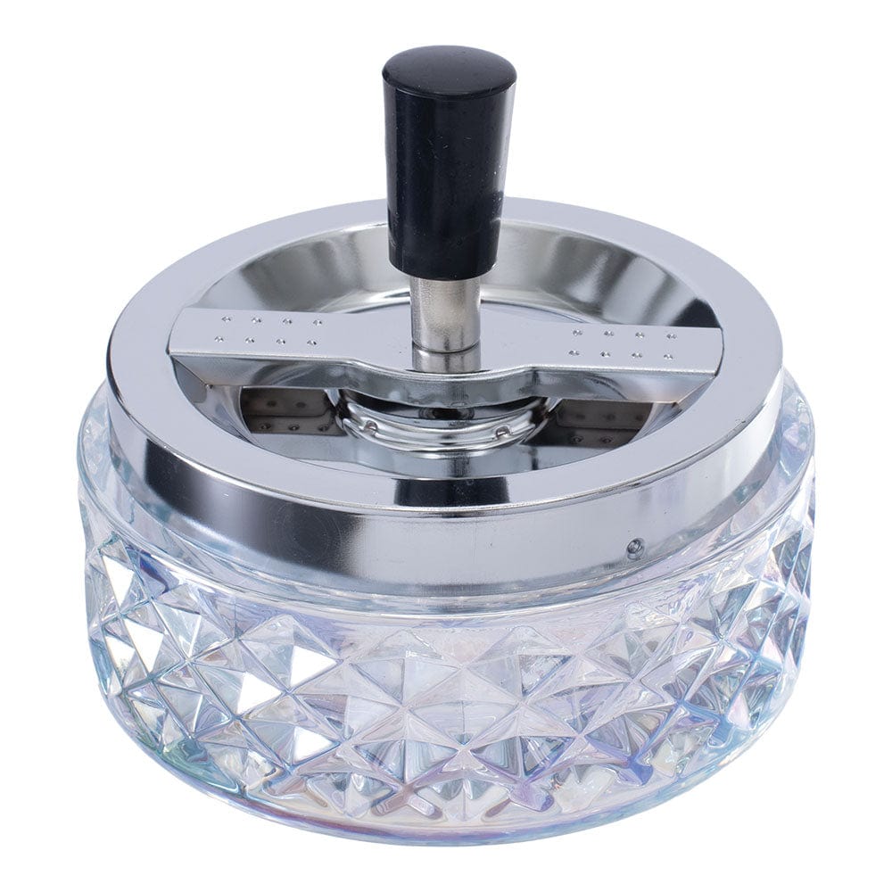 A close-up, angled view of the Gem-cut Glass Spinning Ashtray, showcasing its clear, faceted glass design.