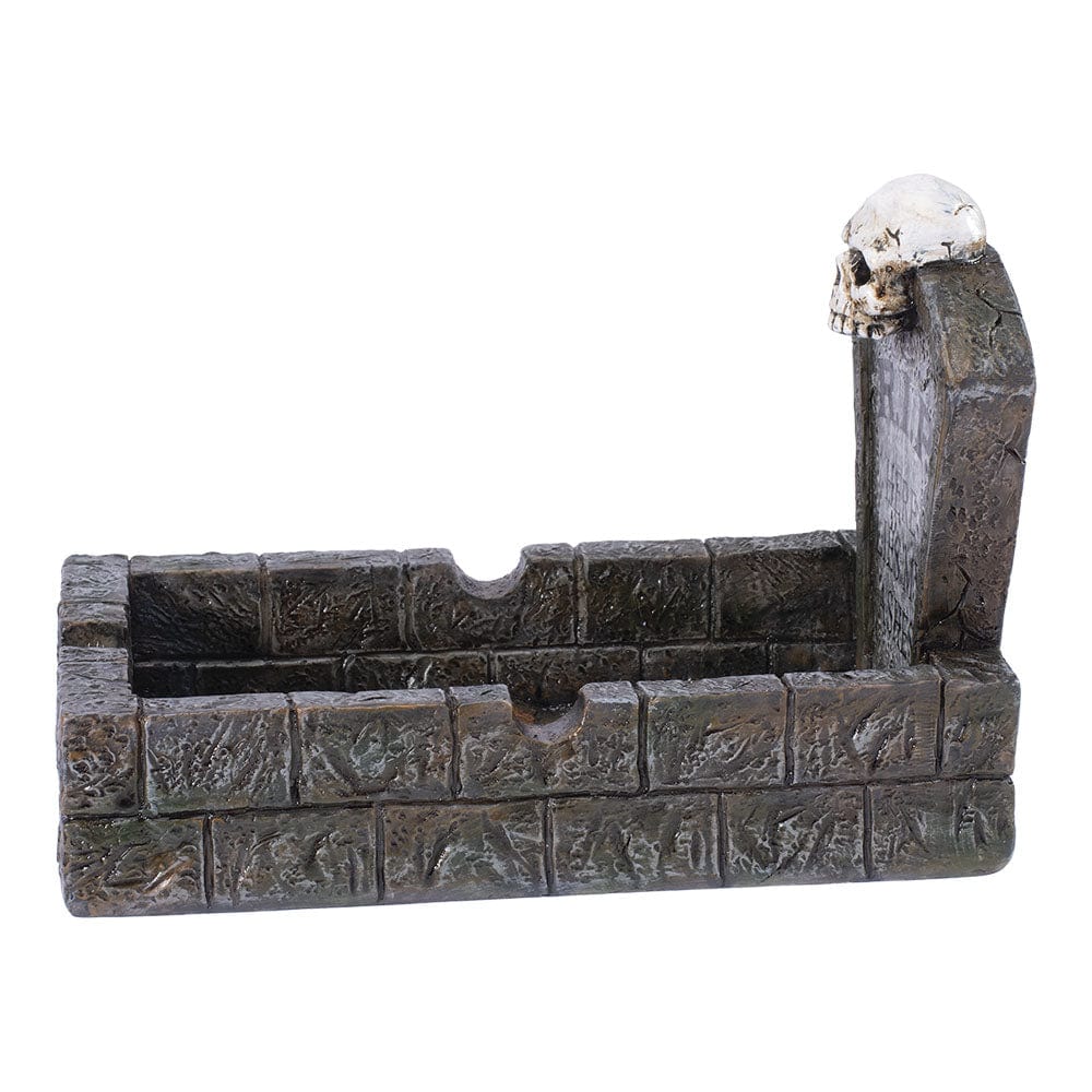 The RIP Tombstone Ashtray is shown in a side view, resembling a dark grey stone tombstone with a bowl-shaped depression.