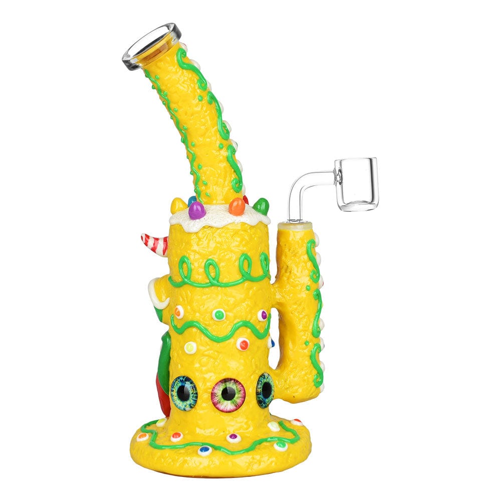 A three-quarter view of the 9.75" Gingerbread Monster Dab Rig, featuring colorful, whimsical details and a glass joint.
