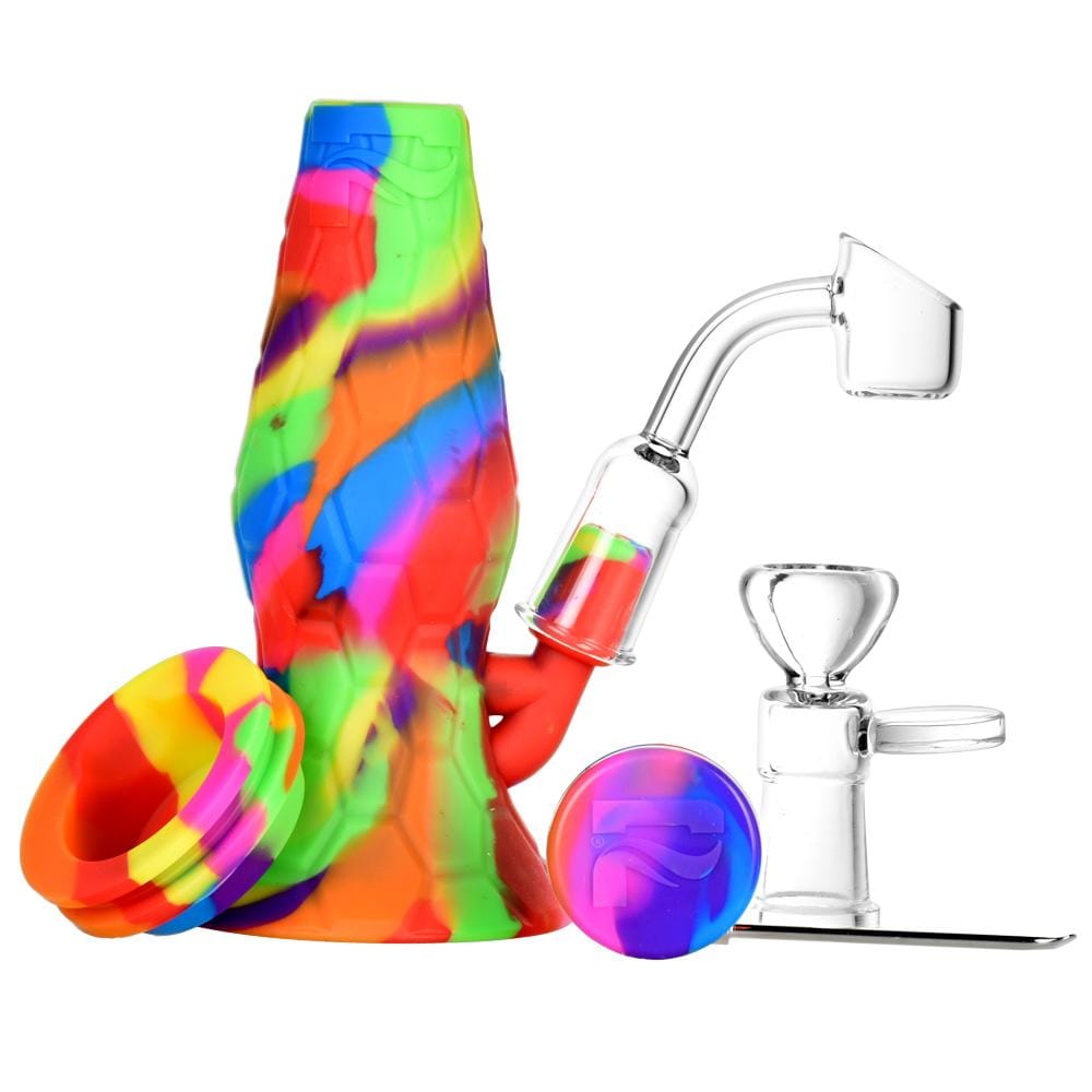 A three-quarter view of the Pulsar RIP Series Mini Lava Flow Dual Rig, featuring colorful, swirled glass and a detached mouthpiece.