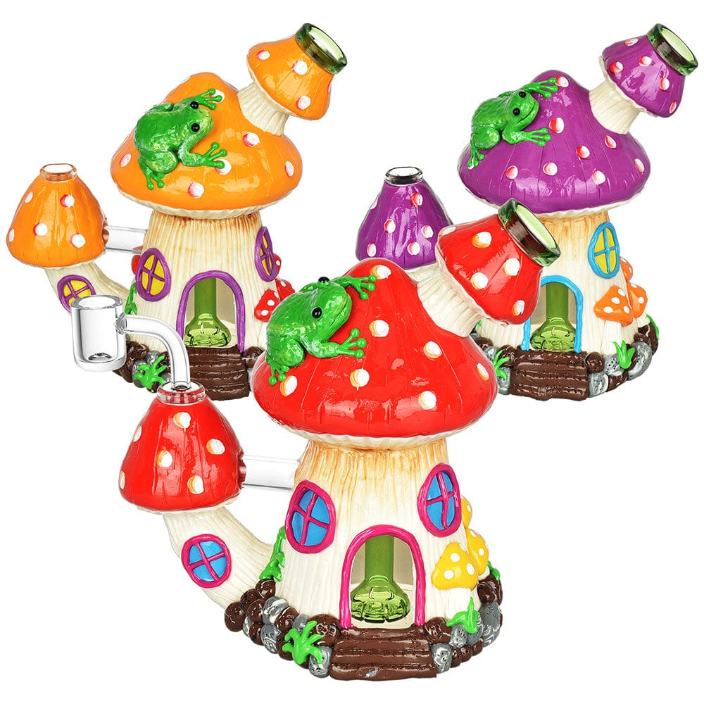 A colorful arrangement showcases the Toadstool House Dab Rig - 7.5"/14mm F/Clrs Vry, styled as whimsical mushroom houses with vibrant, glazed finishes.