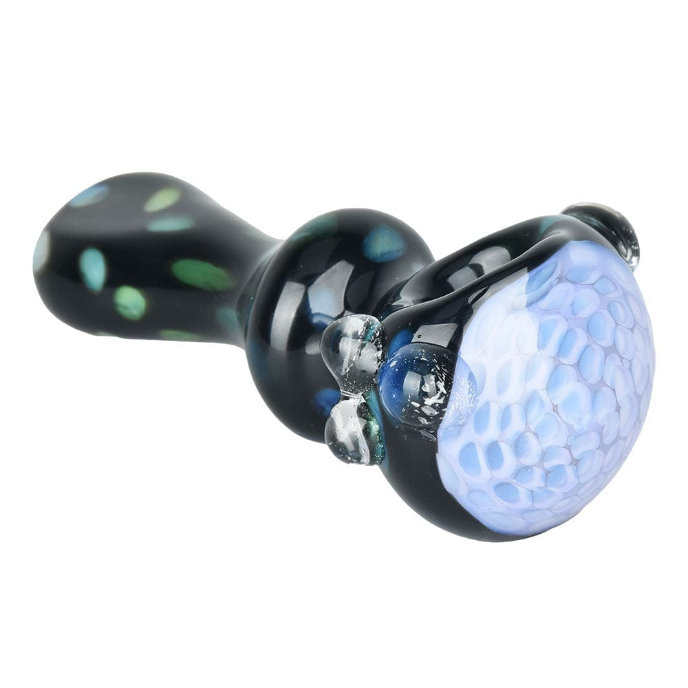 A side view of the 4-inch Mad Magic Spoon Pipe, showcasing its curved glass body with vibrant green accents.