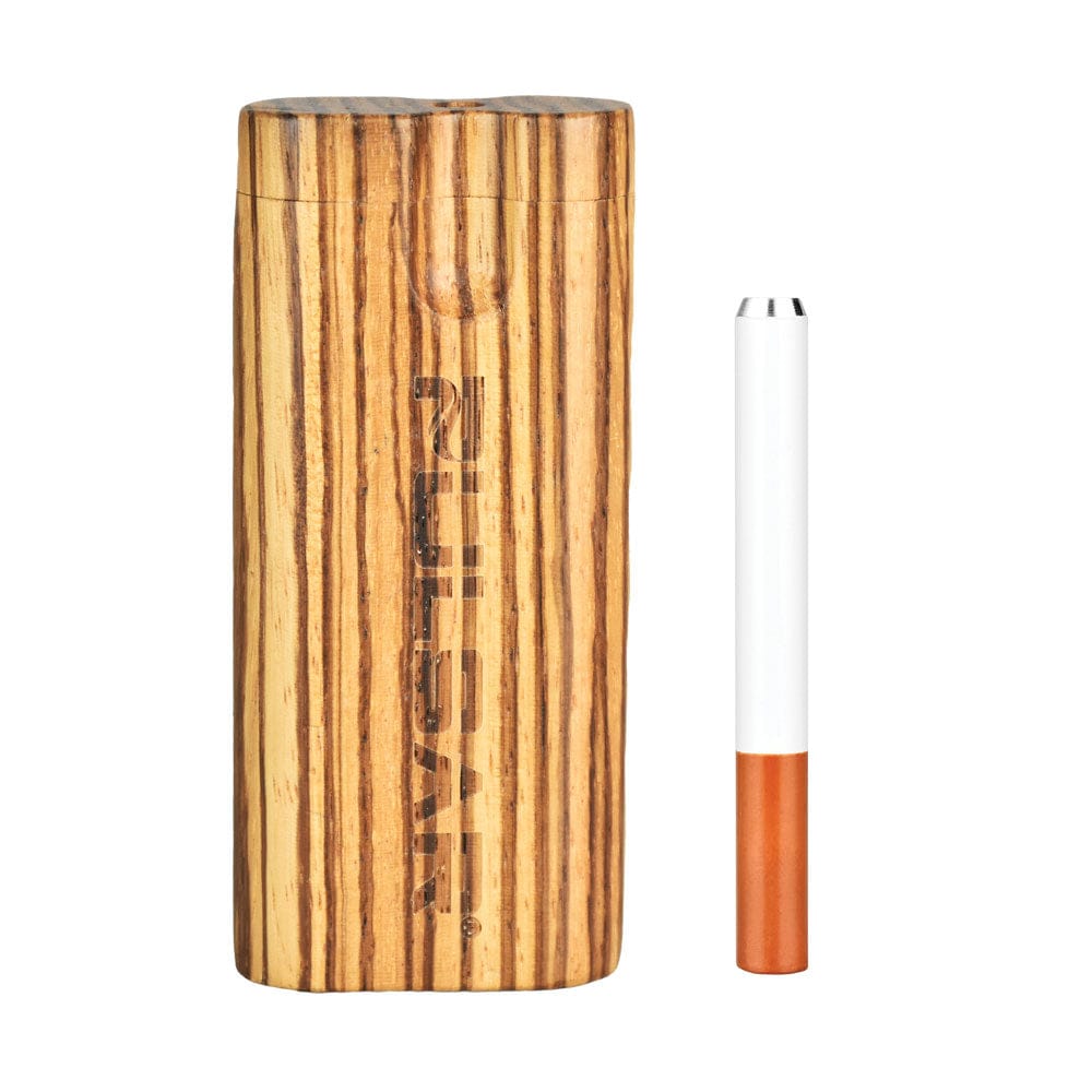 A side view of the Pulsar Straight Wood Twist Top Dugout, showing a cylindrical, wood-grain case next to a rolled cigarette.