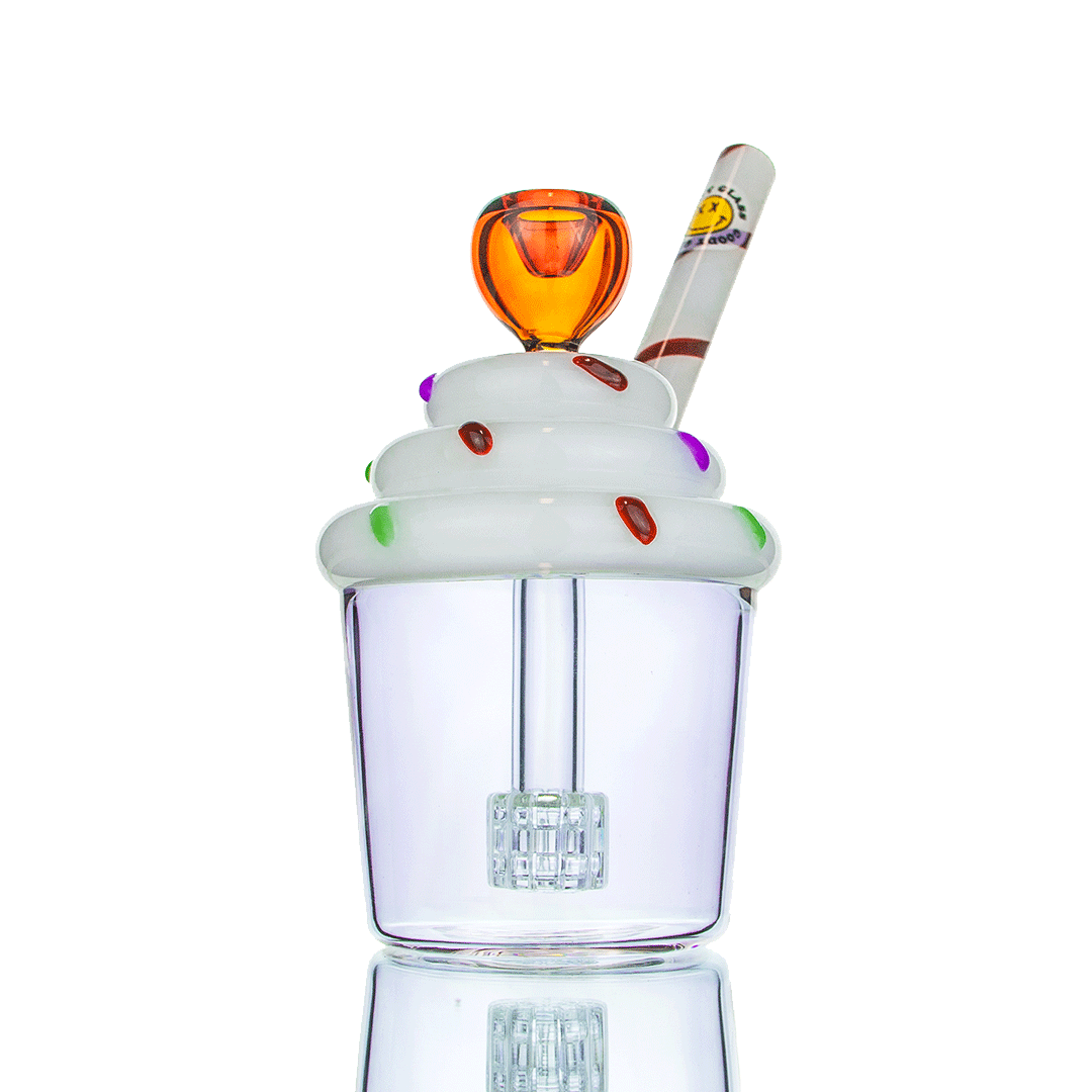 A studio shot displays the Goody Cupcake Bubbler, a clear glass piece with a whimsical, rounded shape and reflective surface.