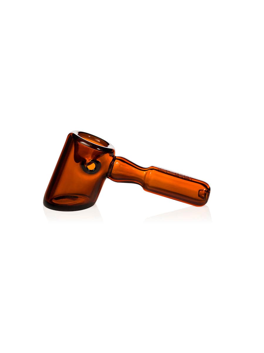 A studio shot of the GRAV® Hammer Hand Pipe, showcasing its sleek, brown glass design from a slightly elevated angle.