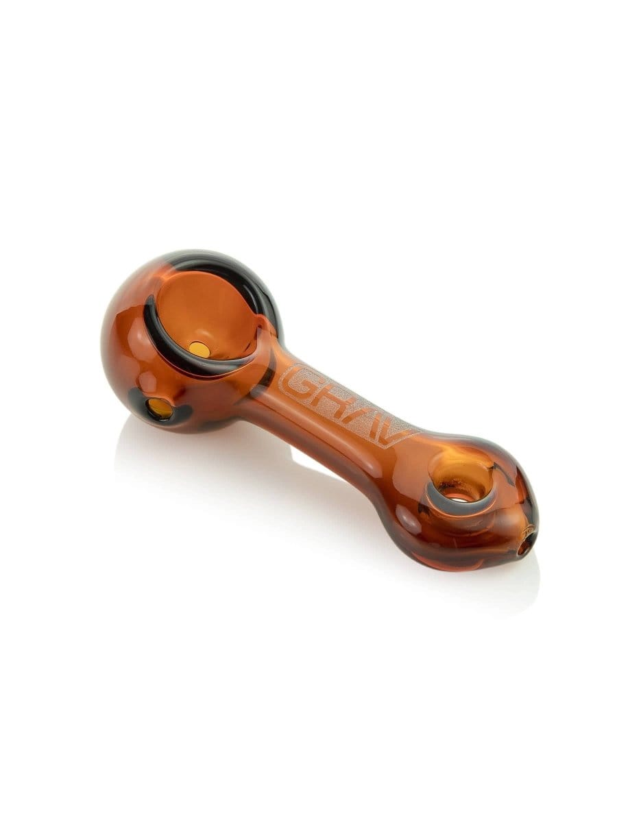 A side view of the GRAV® Mini Spoon Pipe, showcasing its curved form and polished, amber-toned glass.