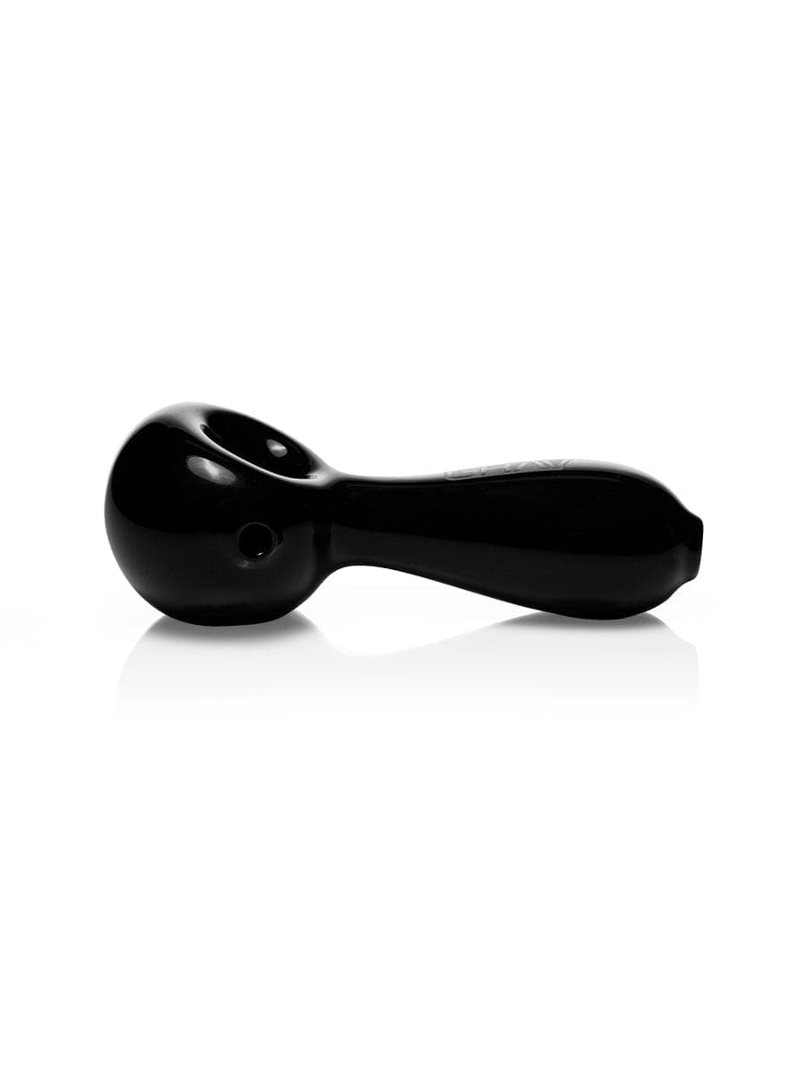 A side view of the GRAV® Large Spoon pipe in black, casting a soft shadow on a white surface.