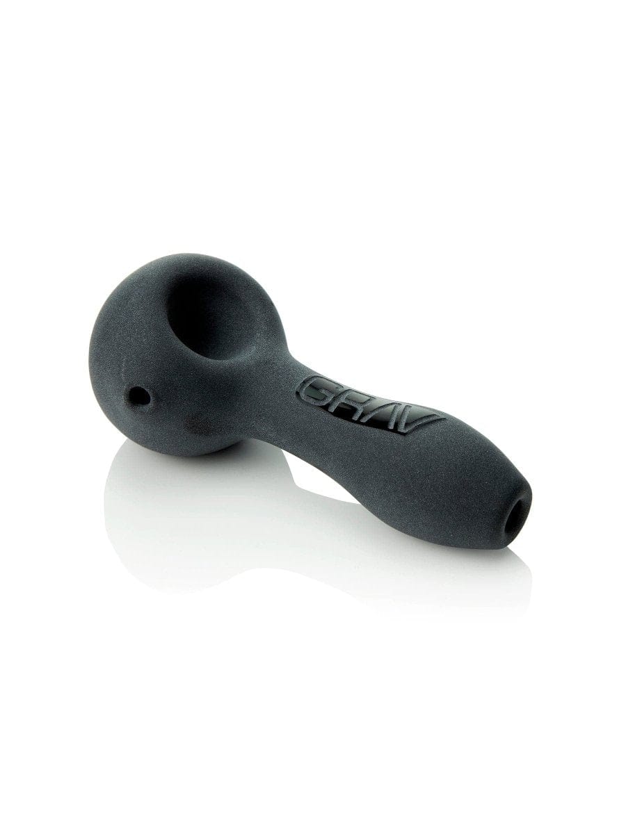 A three-quarter view of the GRAV® Sandblasted Spoon Pipe, resting on a reflective surface with subtle lighting.