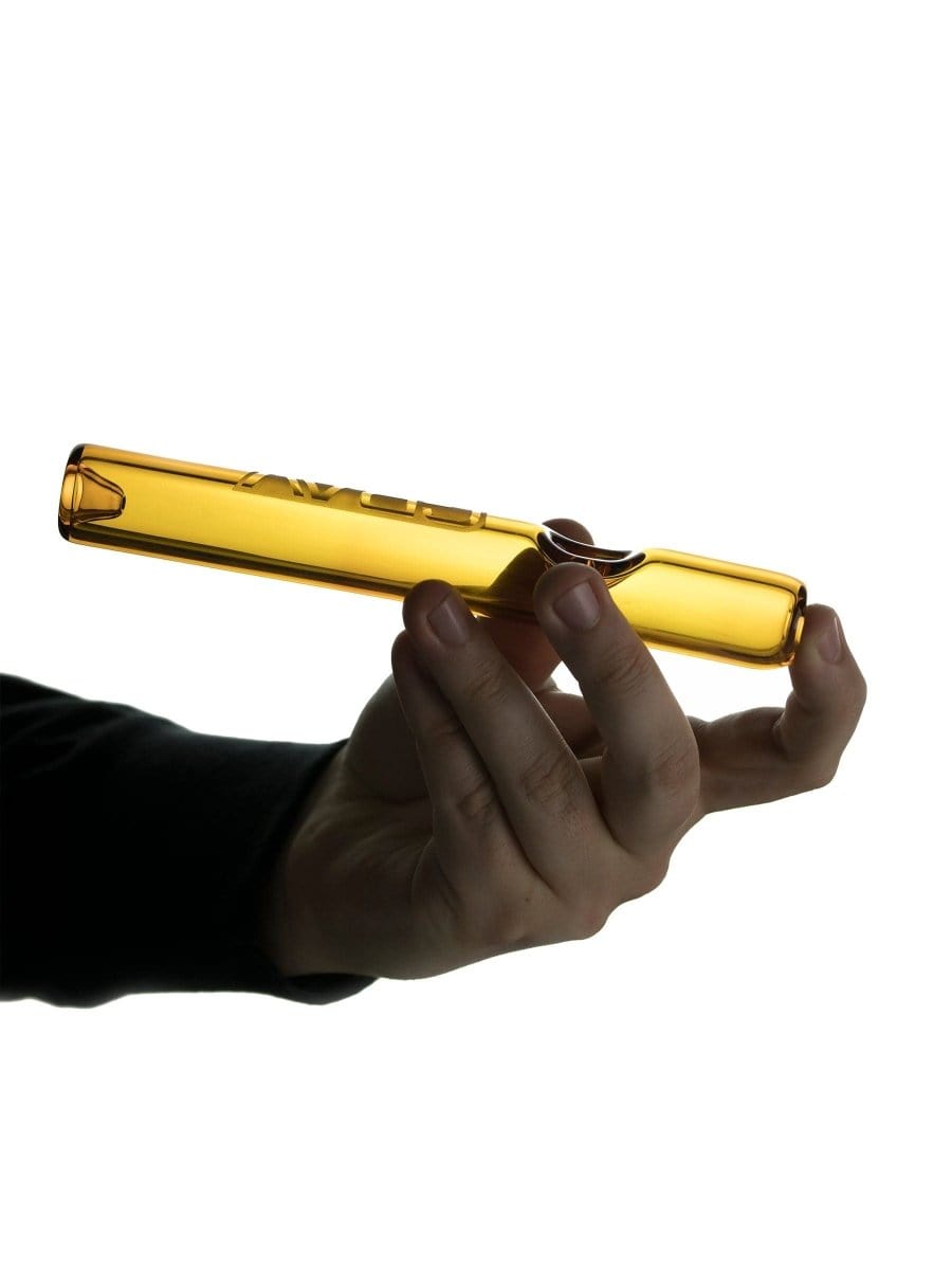 A hand holds the GRAV® Classic Steamroller, showcasing its clear glass construction and simple, cylindrical shape.