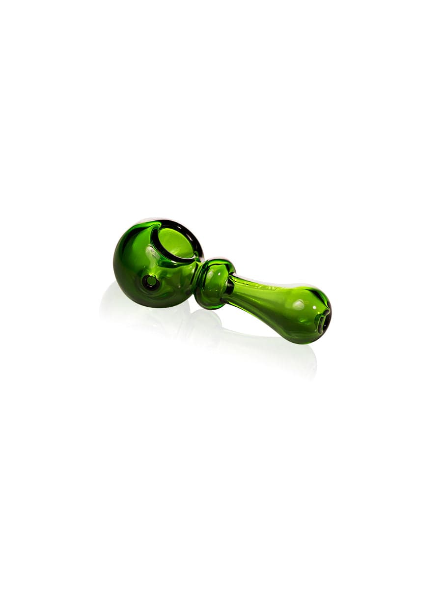 A side view of the GRAV® Bauble Spoon in transparent green glass, reflecting light on a neutral surface.