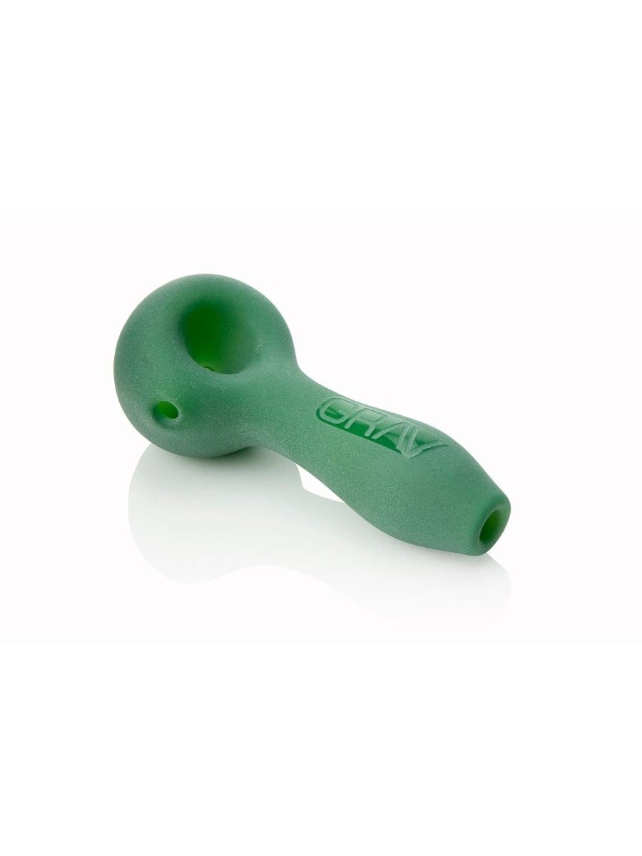A side view of the GRAV® Sandblasted Spoon Pipe with a matte finish, resting on a reflective surface.