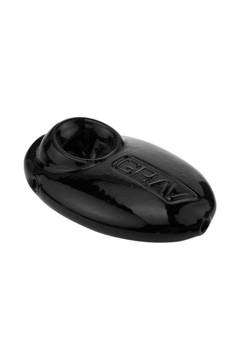A close-up, angled view of the Grav Labs Pebble Spoon, showcasing its smooth, dark glass construction.