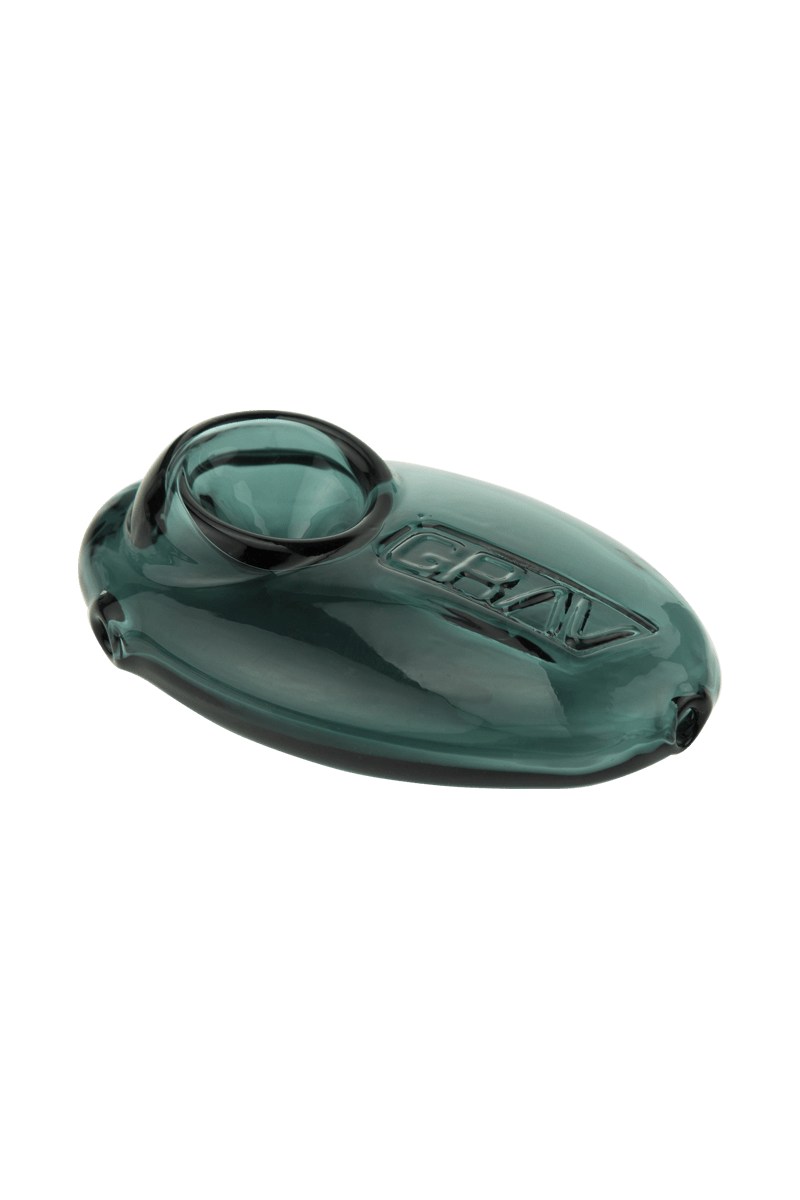 A close-up shot of the Grav Labs Pebble Spoon, showcasing its smooth, rounded shape and dark green glass material.