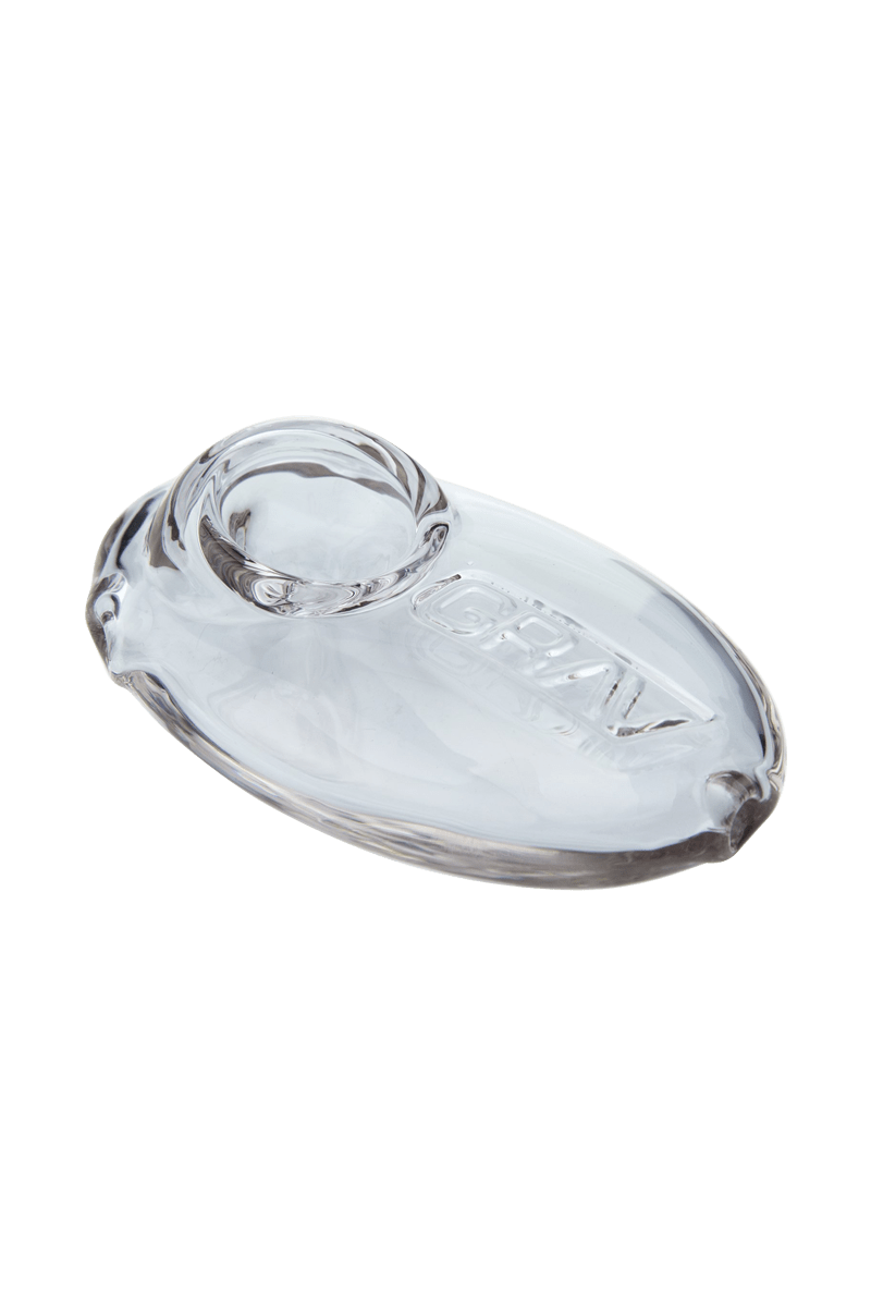 A side view of the Grav Labs Pebble Spoon, a small, clear glass pipe with a rounded bowl.