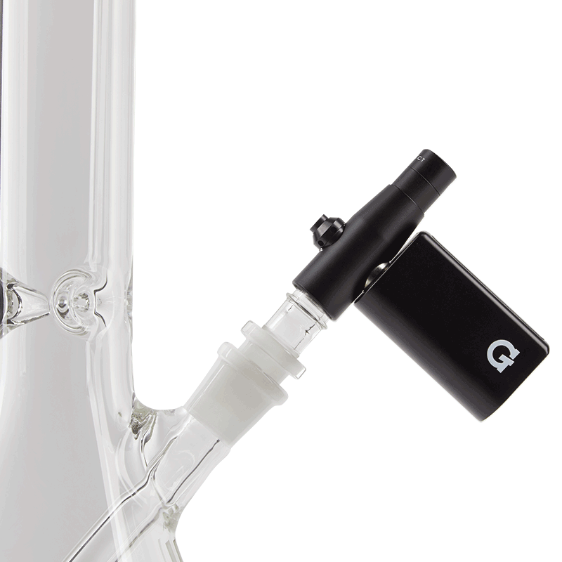 A close-up view of the G Pen Connect Vaporizer attached to a clear glass tube, highlighting its sleek, black design.