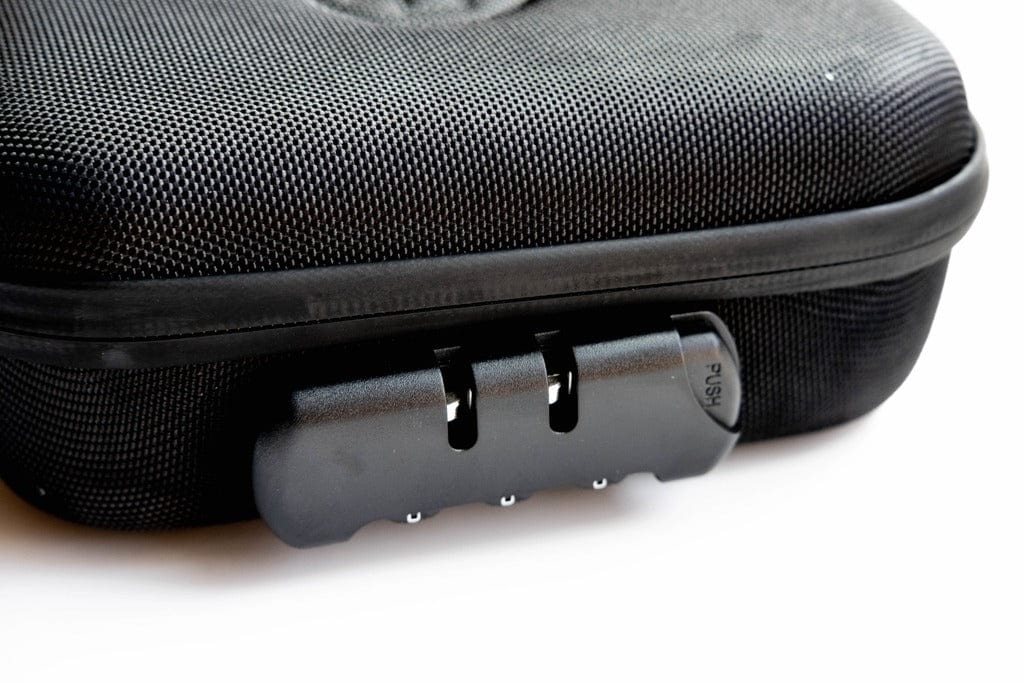 Close-up of The Very Happy Kit, showing a black, textured case with a latch and a silver push button.