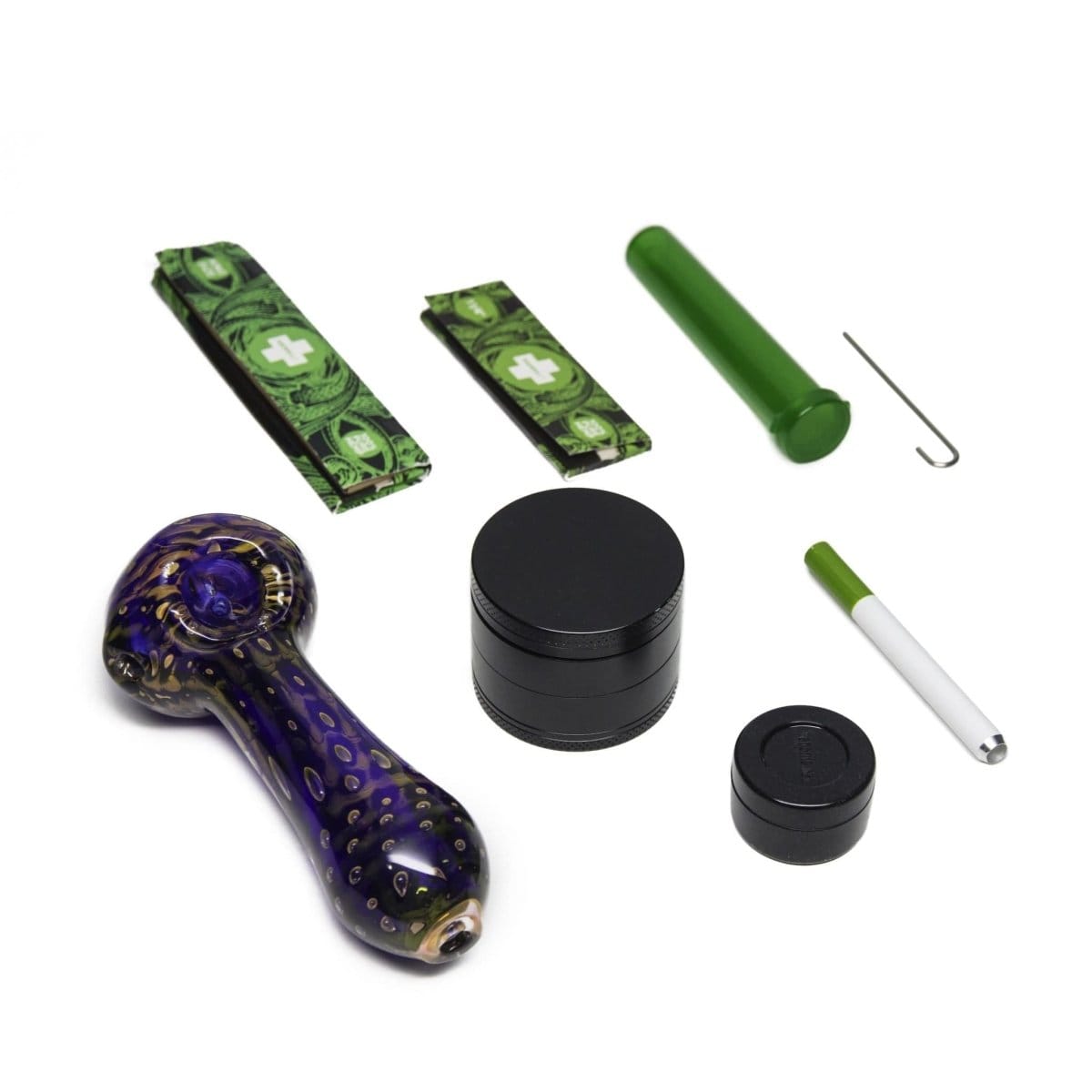 Overhead shot of The Very Happy Kit, showing a small grinder, rolling papers, and a glass smoking tip arranged on a white surface.