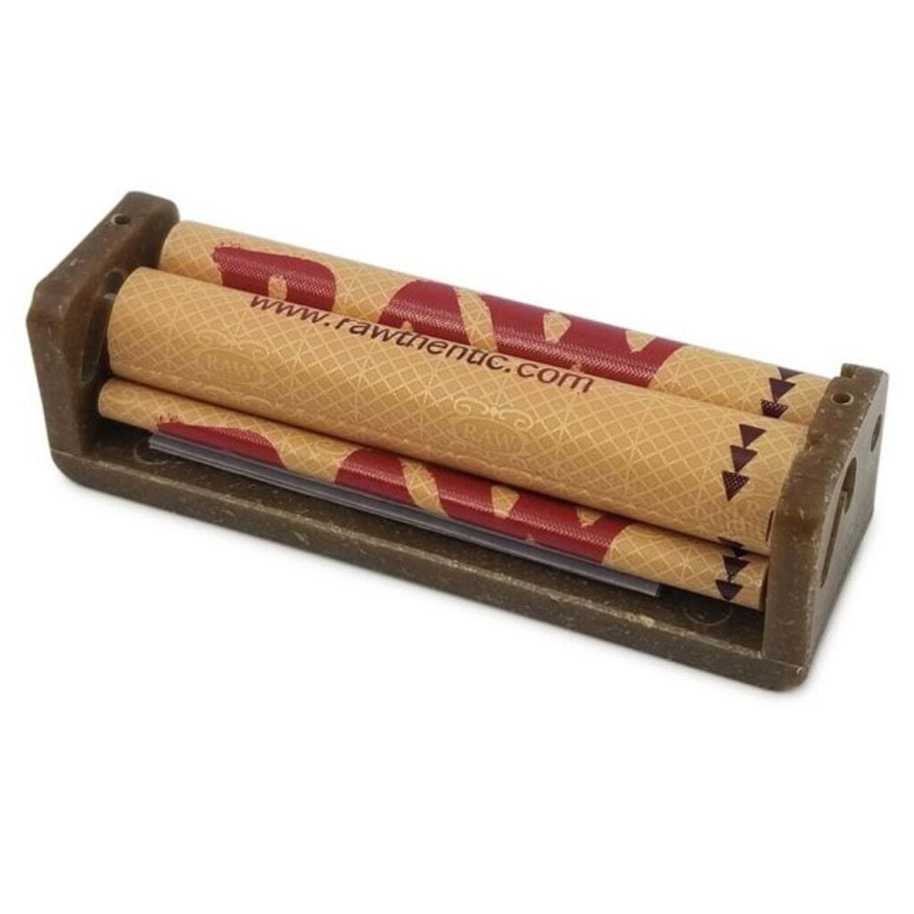 A top-down view of the RAW Rolling Machine, a wooden and metal tool for hand-rolling cigarettes.