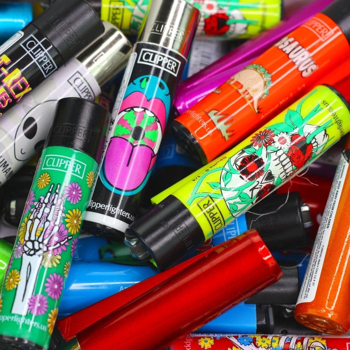 An assortment of colorful Assorted Clipper Lighters stacked at a slight angle with branding visible on each.