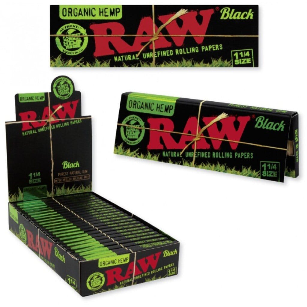 A close-up, angled view of RAW Black Organic Hemp 1 1/4 rolling papers packaging, featuring a textured black design.