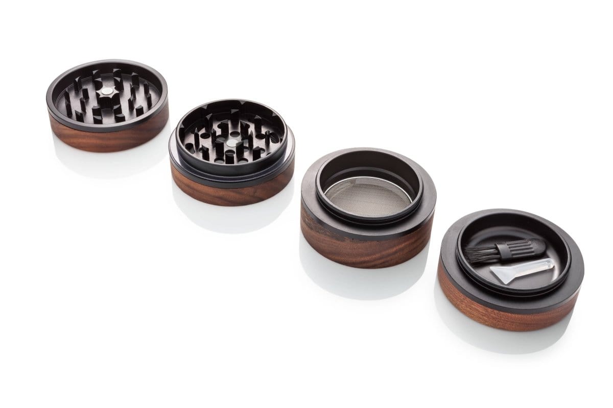 Overhead view of the Troy Herb Grinder, featuring a multi-part silver and dark metal construction on a neutral background.