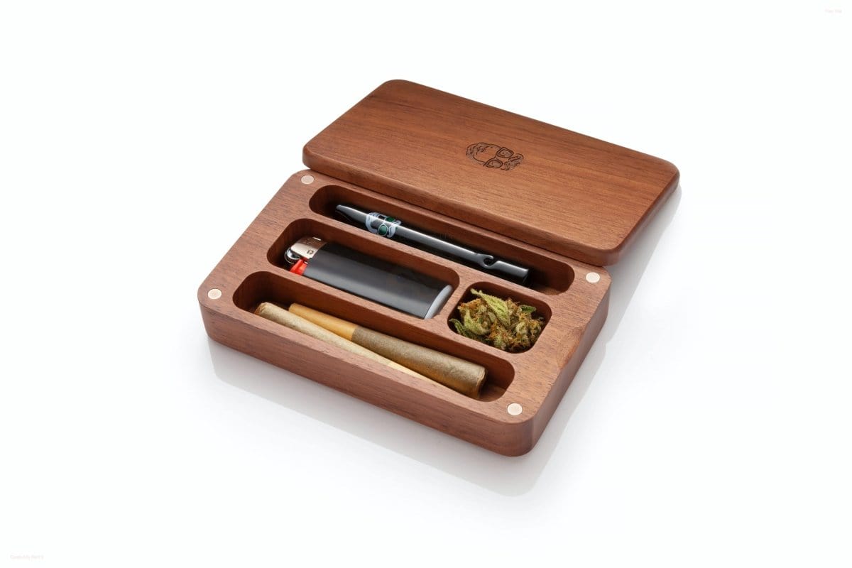 An open Oakleaf Mini Case Stash Box with Glass One Hitter inside, viewed from above, showcasing its wooden construction and contents.