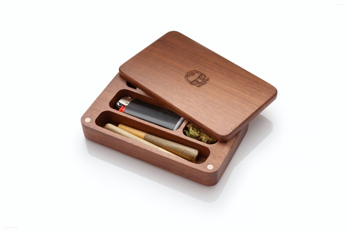 An open Oakleaf Mini Case Stash Box with Glass One Hitter shows a small wooden case with a glass one-hitter inside.