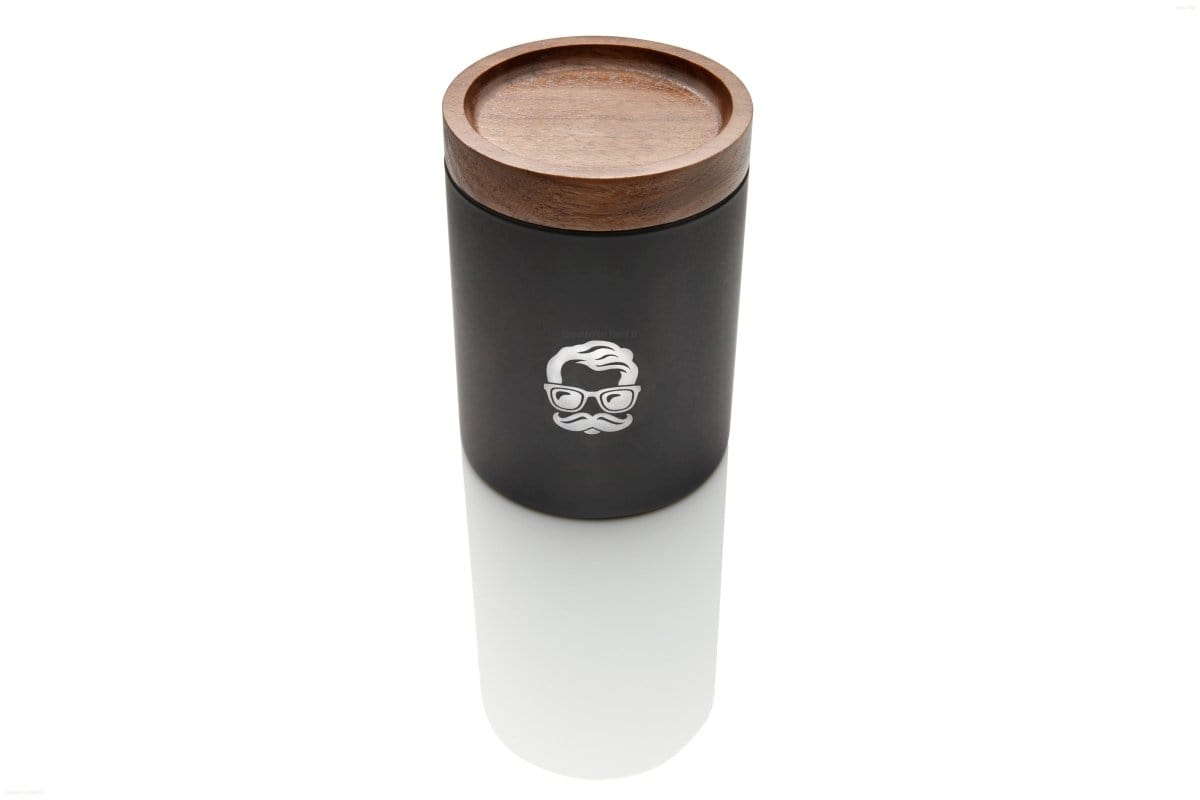 Front view of the Canna Stash Jar, a sleek, dark container reflecting on a polished surface.