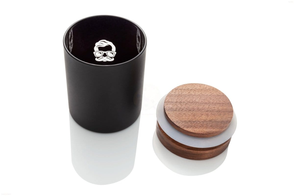 A high-angle view of the Canna Stash Jar with its lid beside it on a clean, white surface.