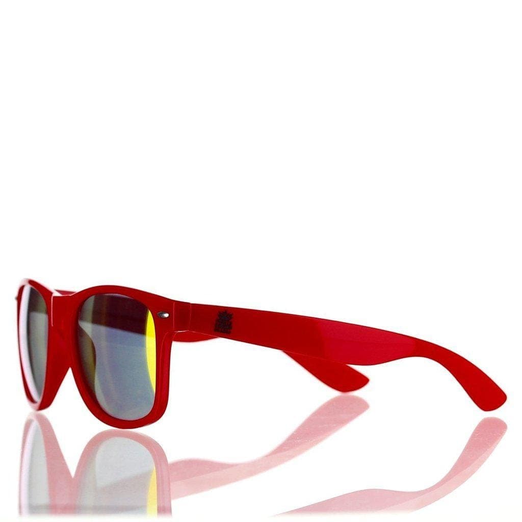 A side view of the Daily High Club x Smoker Shades Sunglasses reflecting on a glossy surface, emphasizing their sleek, dark design.