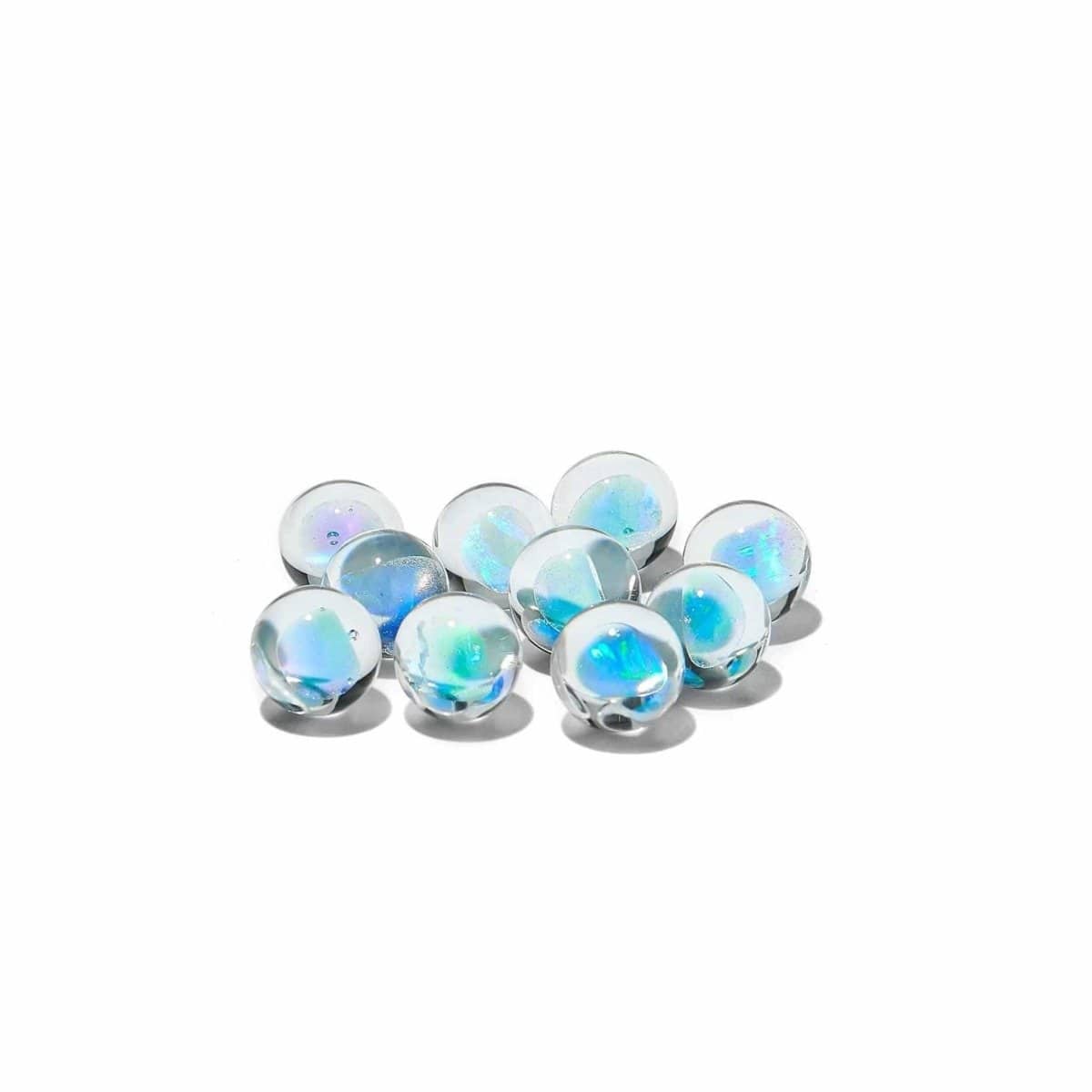 A top-down view of several Blue Opal marbles arranged on a clean white surface, reflecting light with a subtle sheen.