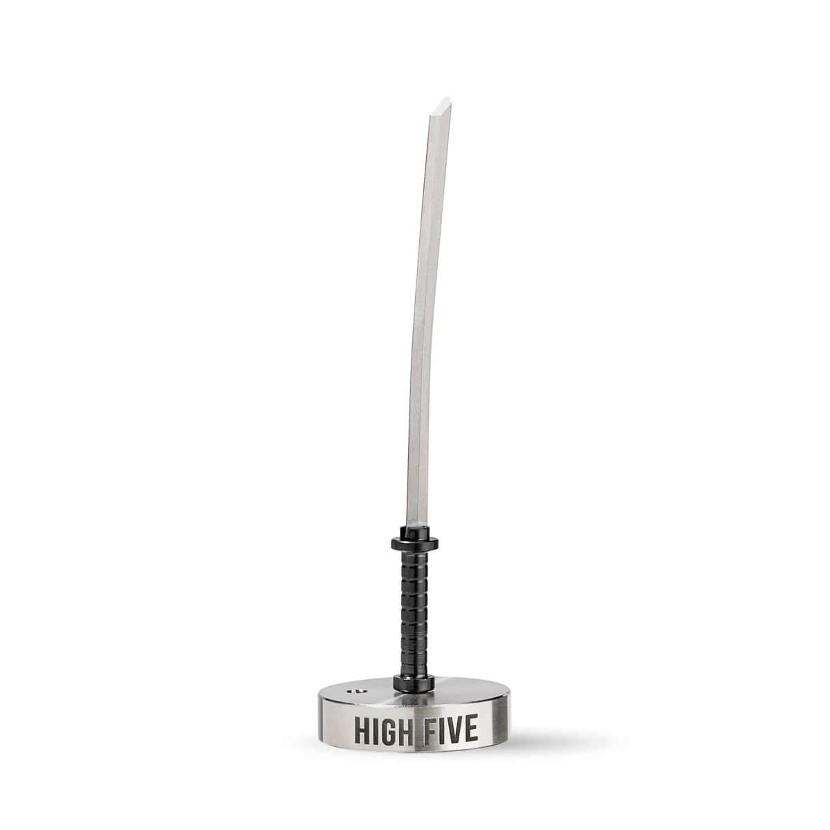 Center-frontal view of the LCD E-Nail Titanium Nail Kit showing a vertical titanium nail with a black ribbed handle mounted in a round silver base engraved "HIGH FIVE" against a white background