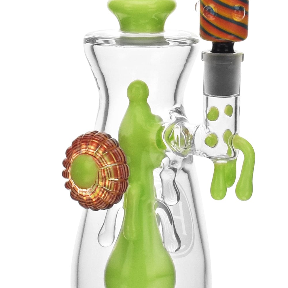 A three-quarter view of the High Society  Jupiter Premium Wig Wag Waterpipe (Slime Green) with a unique, curved shape and clear glass construction.