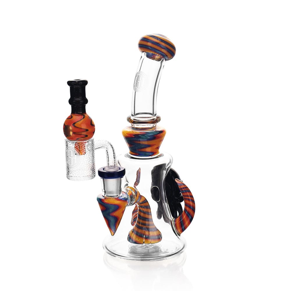 A three-quarter view of the High Society - Tulu Premium Wig Wag Concentrate Rig, showcasing its blue and yellow accents against a white backdrop.