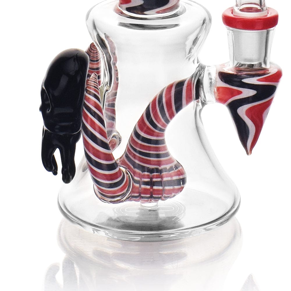A three-quarter view of the High Society - Tulu Premium Wig Wag Concentrate Rig, showcasing its red and black striped glass design.