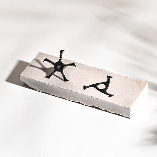 A minimalist, overhead view of the KLIP Blades, showcasing their sleek, dark silhouette against a light surface.