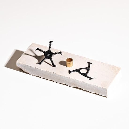 A close-up, angled view of the KLIP Blades, showcasing their unique, metallic design against a neutral surface.