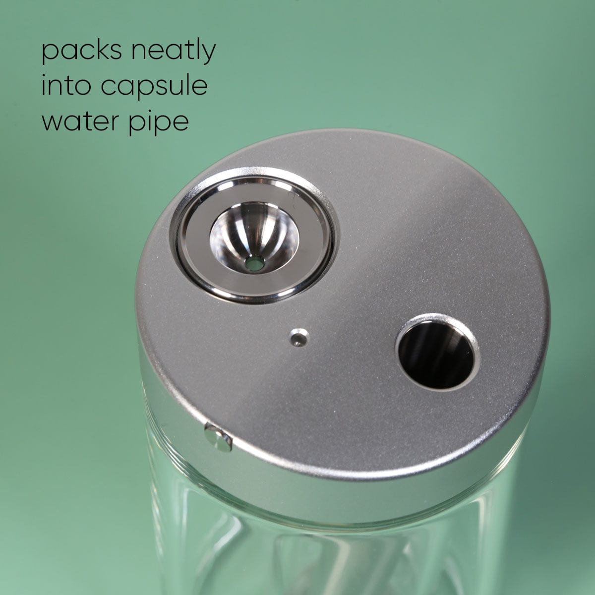 Close-up of the Stainless Steel Bowl Piece, showing its circular shape and smooth, reflective surface against a blurred green background.