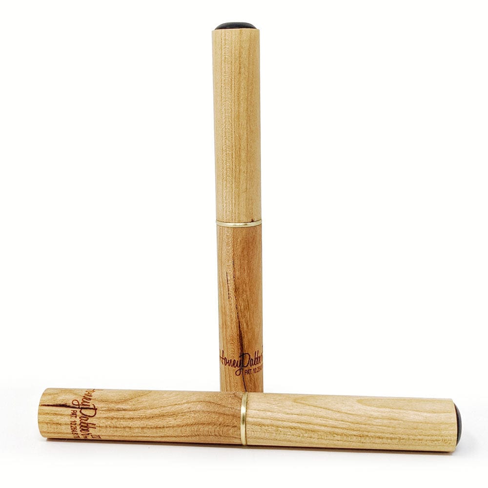 A close-up of the Honey Dabber II Cherry Wood Dab Straw, angled slightly against a blurred background.