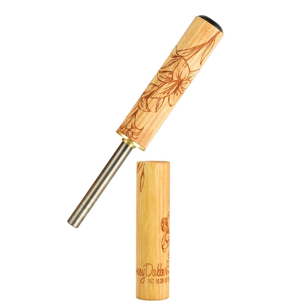 Front view of the Honey Labs Honey Dabber II Lilly Limited Edition, with a delicate floral pattern carved into the wooden handle.